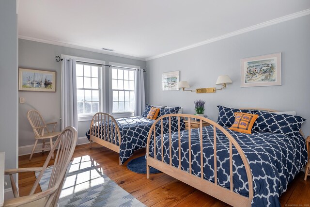 bedroom with wood-type flooring and crown molding