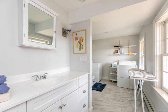 bathroom featuring vanity, a baseboard radiator, toilet, and a healthy amount of sunlight