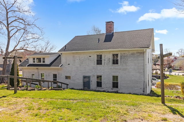 back of house with a lawn