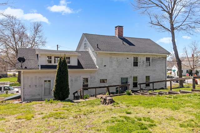 back of property featuring a yard