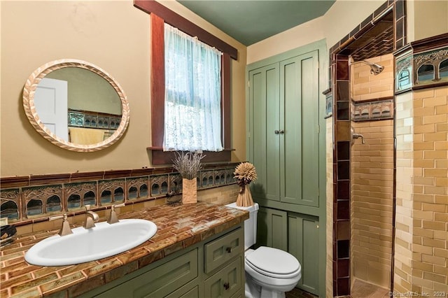 bathroom with vanity, toilet, and a shower