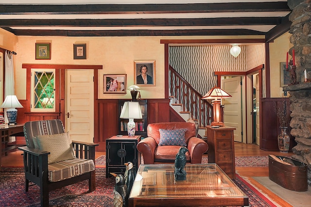 sitting room featuring beam ceiling and wood-type flooring