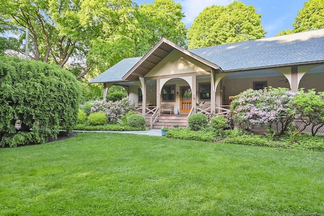 view of front of home with a porch and a front lawn