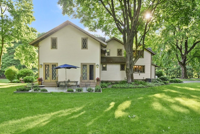 back of property with central AC unit, a patio area, and a lawn