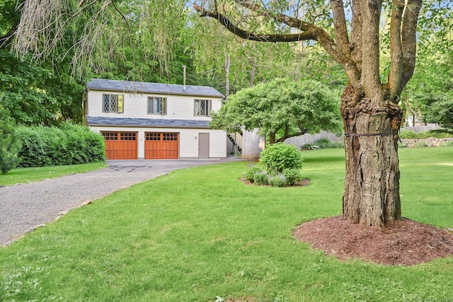 view of front of house featuring a front yard and a garage