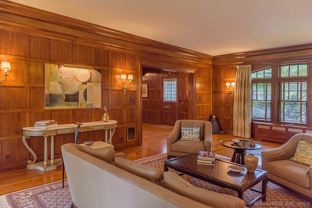 living room featuring wood walls and light hardwood / wood-style floors