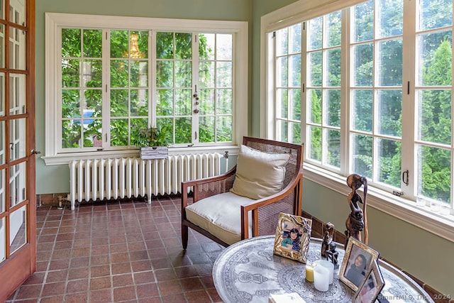 sunroom with radiator heating unit and plenty of natural light