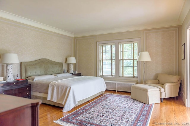 bedroom with crown molding and light wood-type flooring