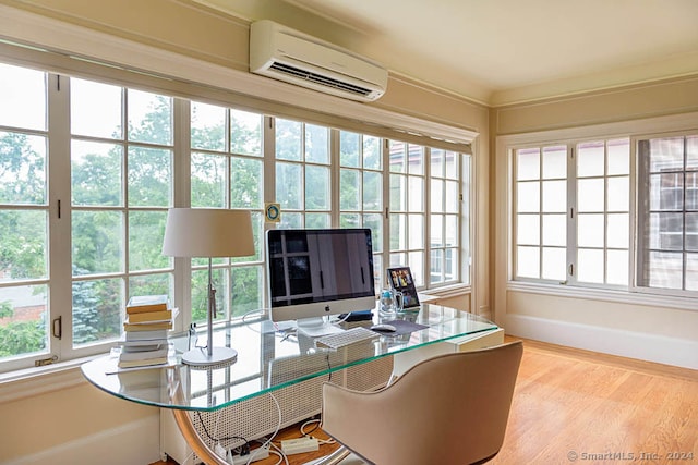 office featuring a wall mounted air conditioner and light hardwood / wood-style flooring