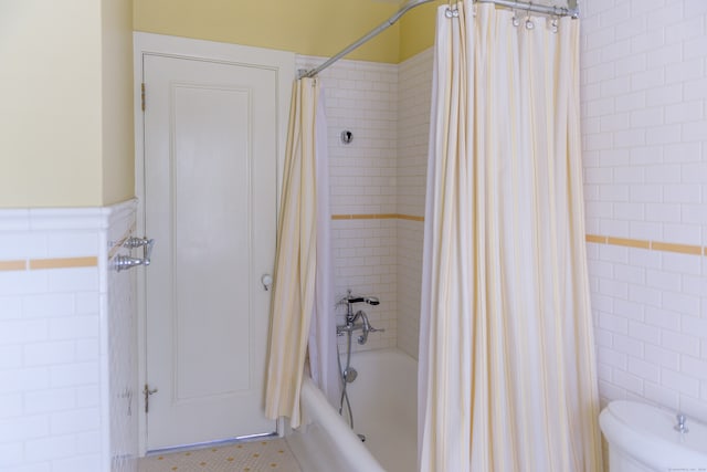 bathroom featuring tile walls, toilet, tile floors, and shower / bathtub combination with curtain