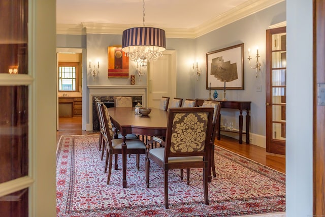 dining room featuring a chandelier, hardwood / wood-style flooring, and ornamental molding