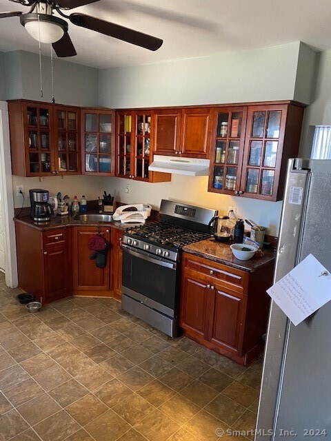 kitchen featuring dark tile floors, ceiling fan, and appliances with stainless steel finishes