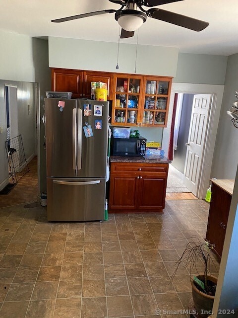 kitchen with stainless steel fridge, ceiling fan, and tile flooring