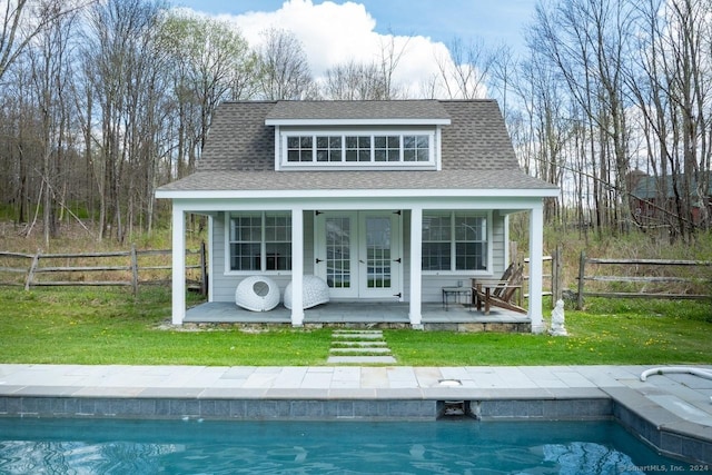 view of outbuilding with a lawn and french doors