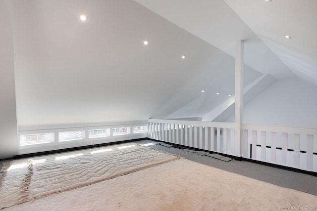 additional living space with carpet and vaulted ceiling