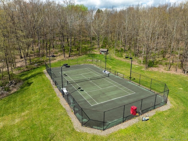 view of tennis court with a lawn