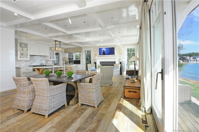 46 Compo Mill Cv, Westport, CT 06880 - dining room with light wood-style flooring, beam ceiling, coffered ceiling, and a fireplace