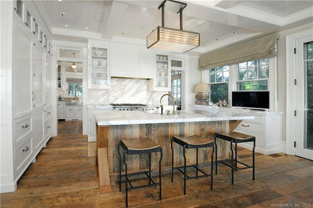 46 Compo Mill Cv, Westport, CT 06880 - kitchen featuring dark wood-style floors, white cabinets, glass insert cabinets, tasteful backsplash, and a kitchen breakfast bar