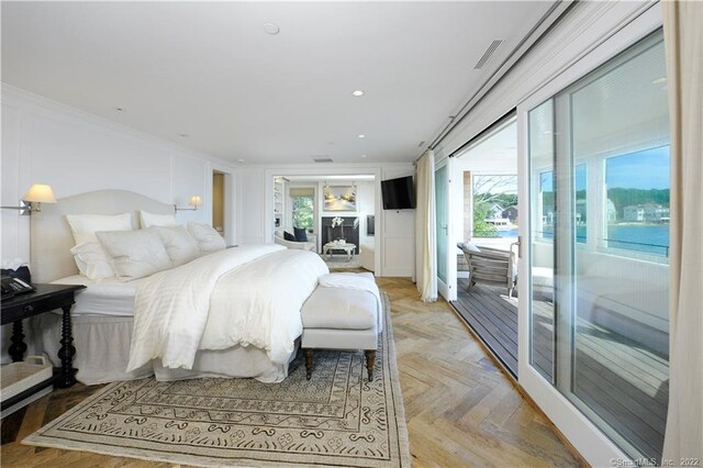 bedroom with light parquet flooring, access to exterior, and multiple windows