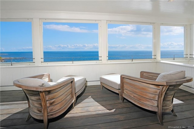 sunroom / solarium featuring a water view and radiator