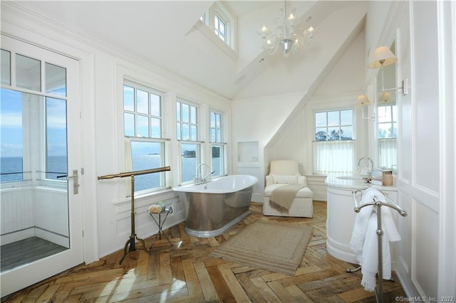 46 Compo Mill Cv, Westport, CT 06880 - full bath with a freestanding bath, a water view, a decorative wall, a high ceiling, and a chandelier