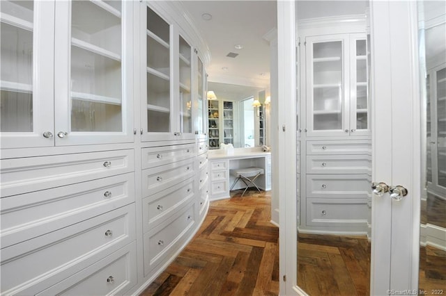 walk in closet featuring dark parquet flooring