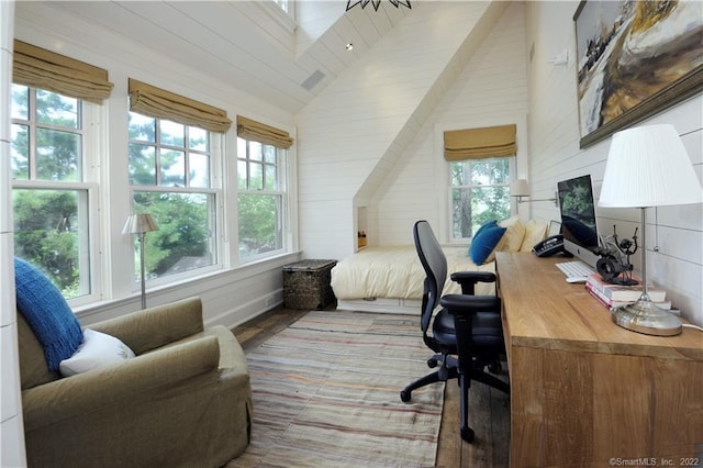 bedroom featuring multiple windows, high vaulted ceiling, and wood-type flooring