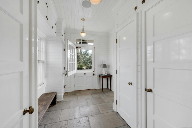 interior space with crown molding and wooden ceiling