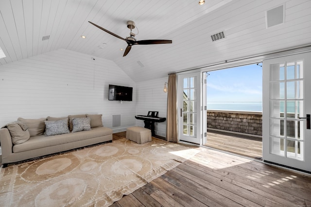 unfurnished living room with hardwood / wood-style floors, a wealth of natural light, wooden ceiling, and ceiling fan