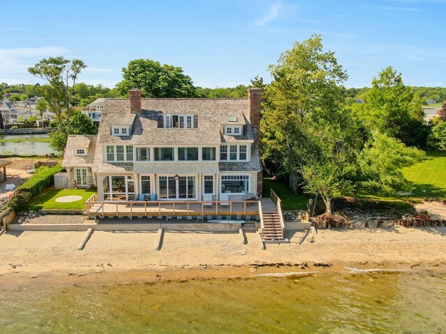 rear view of property with central AC and a deck with water view