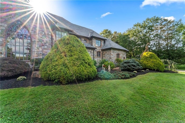 view of side of property featuring a yard