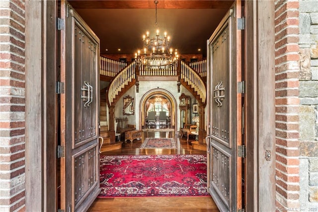 interior space with wood-type flooring and a notable chandelier