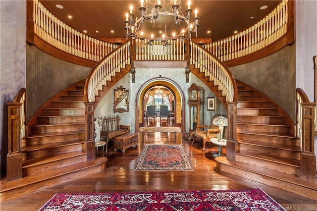 foyer featuring a high ceiling, a notable chandelier, and wood-type flooring