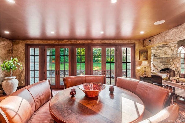 dining room featuring a fireplace and french doors