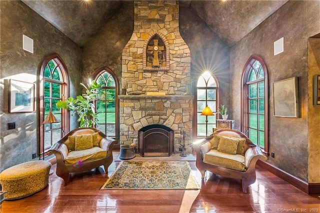 living area with hardwood / wood-style flooring, a fireplace, and a healthy amount of sunlight