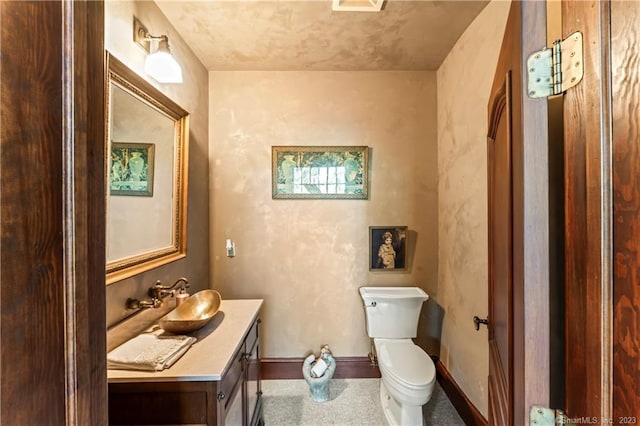 bathroom with toilet and vanity