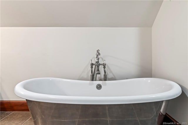 bathroom featuring tile patterned flooring and a washtub