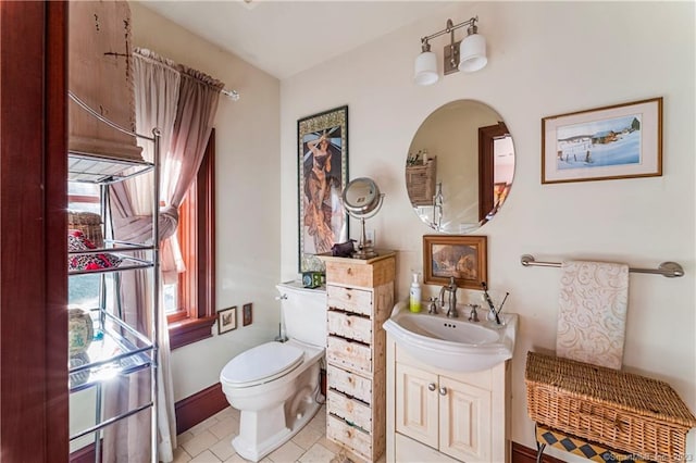 bathroom with vanity, toilet, and tile patterned flooring