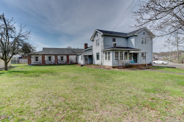 back of house with a yard