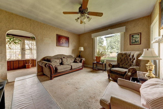 living room featuring ceiling fan and carpet