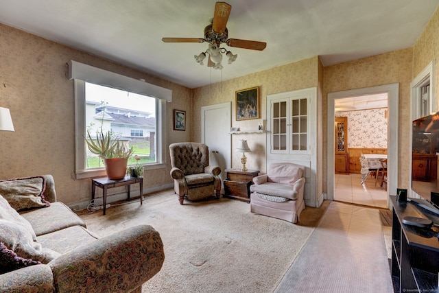 tiled living room with ceiling fan