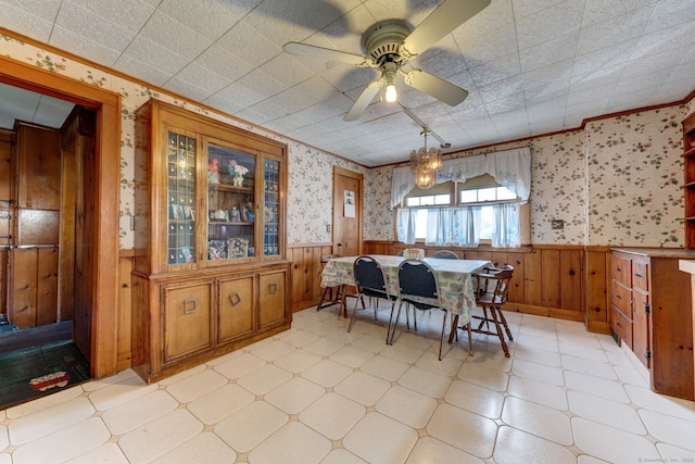 dining space featuring ceiling fan, crown molding, and light tile floors