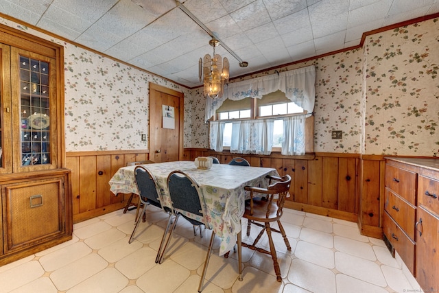 tiled dining room featuring crown molding