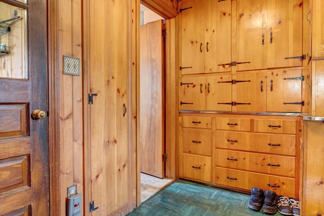 interior space with parquet floors and wooden walls