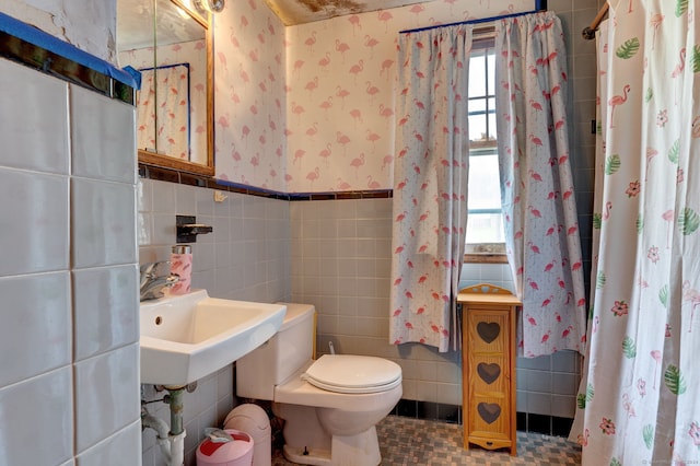 bathroom with tile flooring, tile walls, sink, tasteful backsplash, and toilet