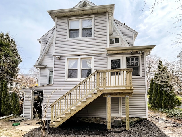 rear view of property with a wooden deck