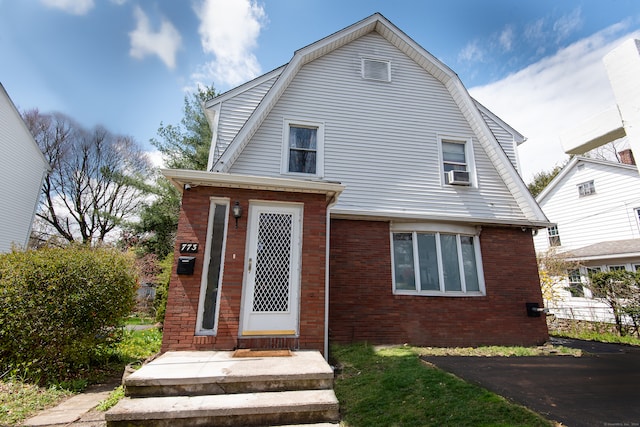 rear view of house featuring cooling unit