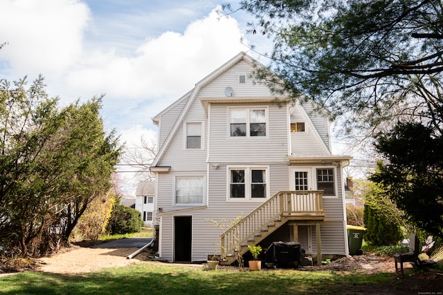 rear view of property featuring a yard