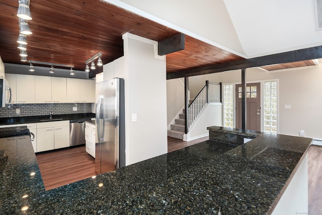 kitchen with white cabinetry, stainless steel appliances, hanging light fixtures, and dark wood-type flooring