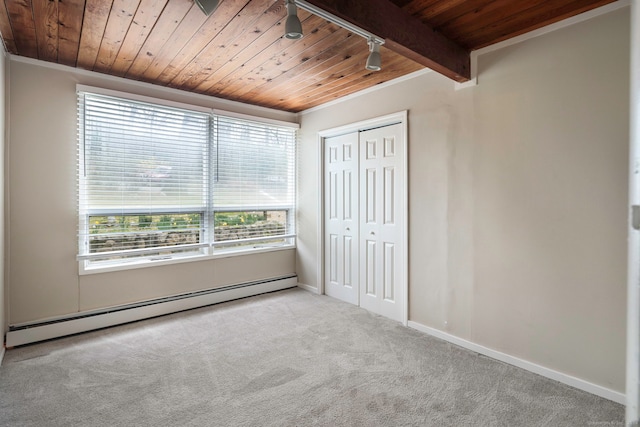 unfurnished bedroom featuring wood ceiling, baseboard heating, and multiple windows